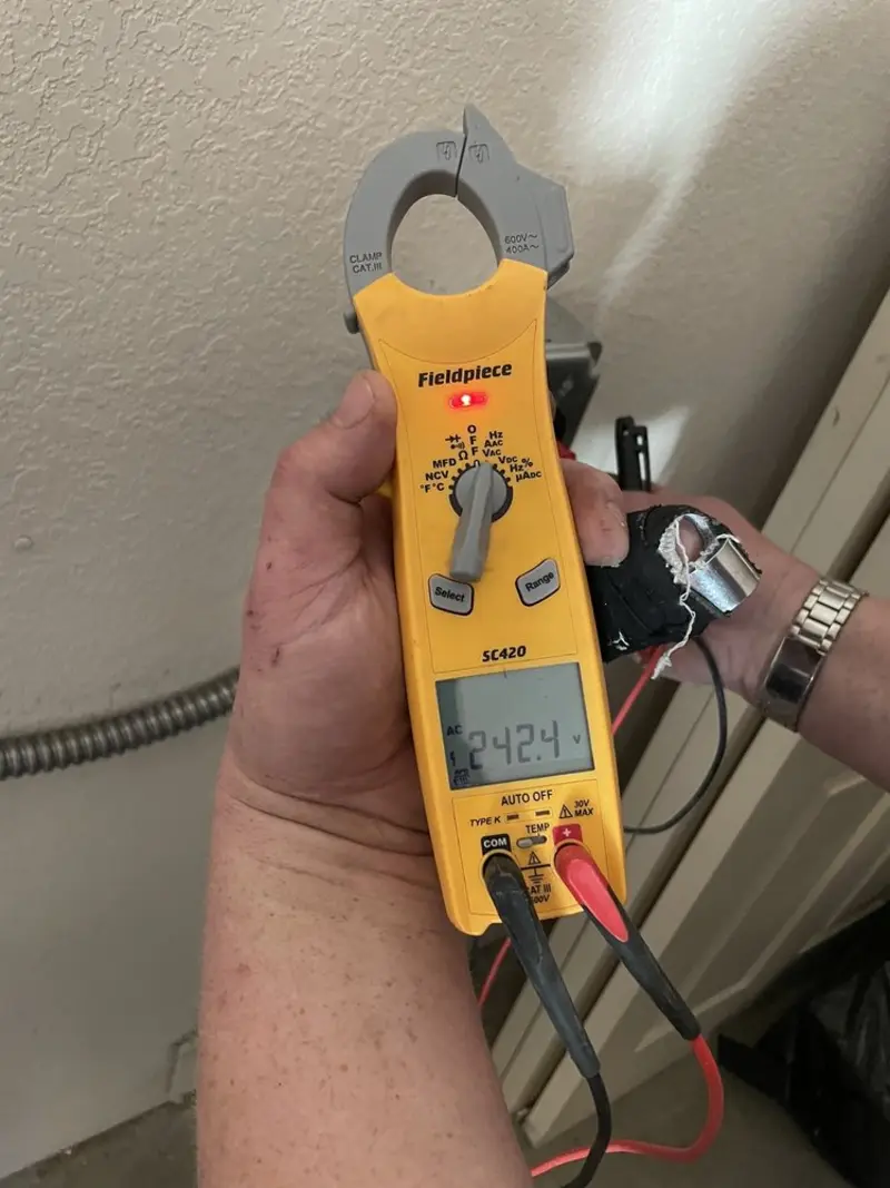 Voltage testing with clamp meter during Outlet Installation in Orchard Mesa